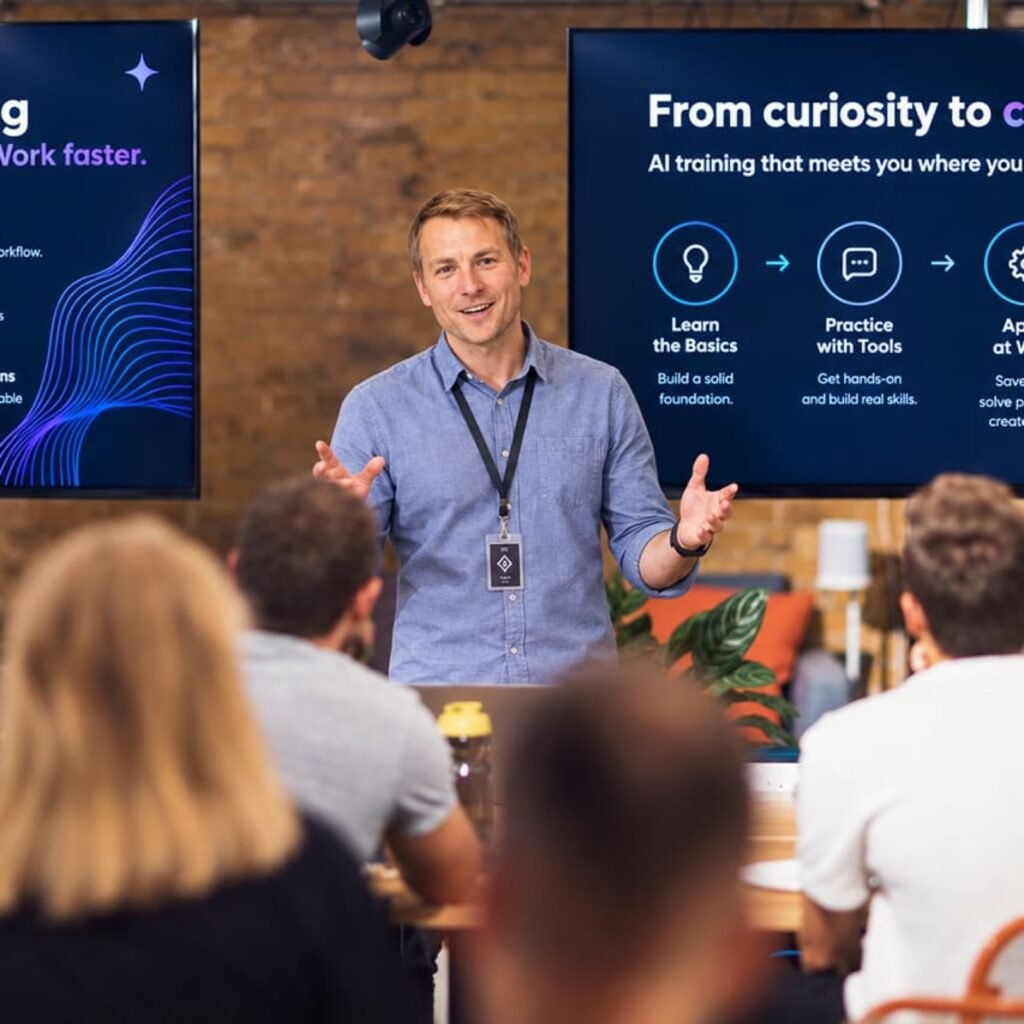 A presenter leading a relaxed AI workshop for a small group